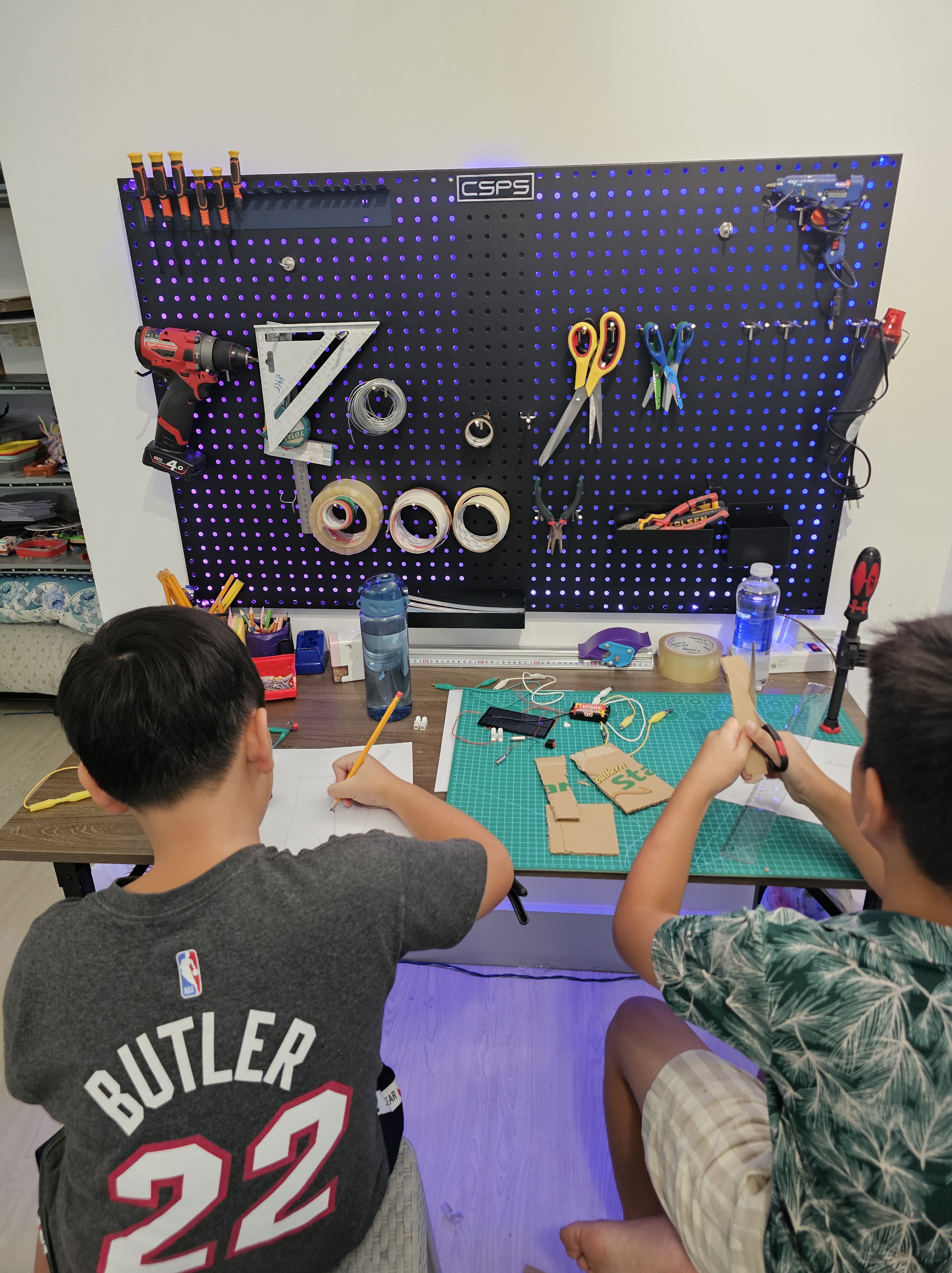 Students building maker projects with LEDs and circuits